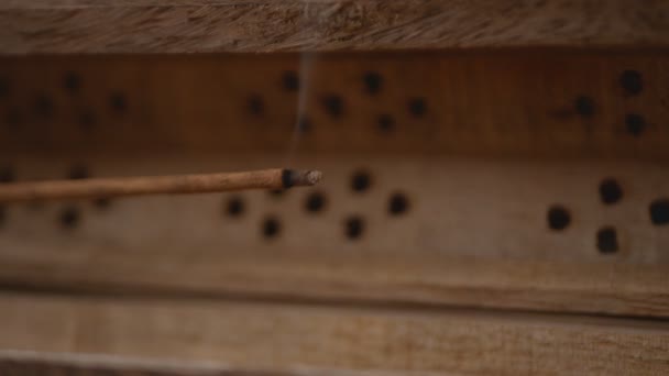 Smoke flows from Incense (aroma sticks) in a unique wooden box. Close-up. Move left. Focus on Incense. - Footage, Video
