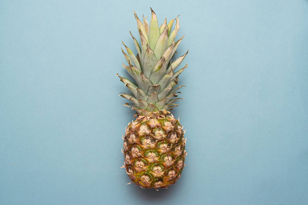 Ripe pineapple fruit on blue background flat lay. - Photo, Image