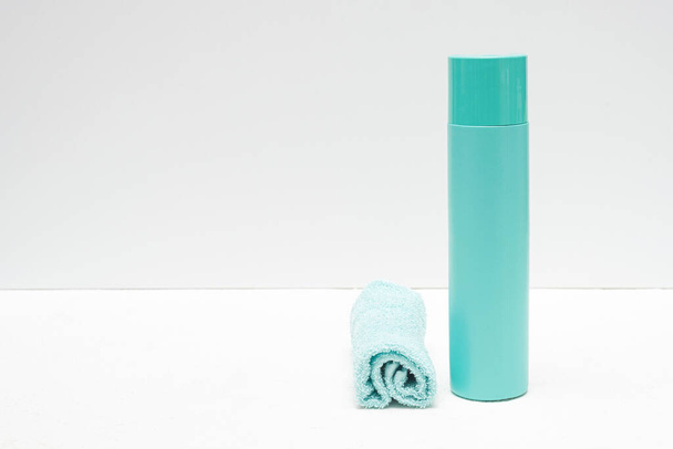 Detergent bottle and towels on white background. - 写真・画像