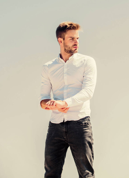 Attractive man taking off shirt. Confident in his appealing. Bearded guy business style. Hot day outdoors. Handsome man fashion model. Sexy macho man. Heat season. Formal fashion. Formal style - Foto, Bild