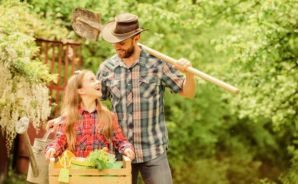 Planting flowers. Plant veggies. Planting season. Inspect your garden daily to spot insect trouble early. Family dad and daughter little girl planting plants. Day at farm. Popular in garden care - Zdjęcie, obraz