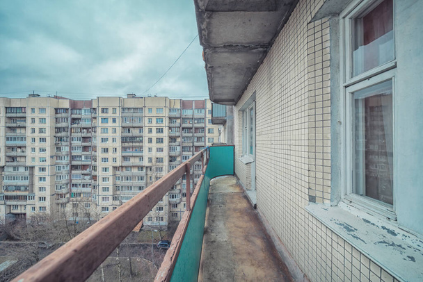 Old common open balcony in high residential apartment building maid of cement - Photo, image