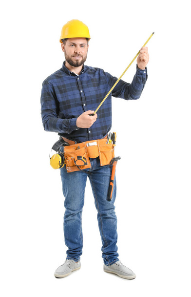 Male worker with tape measure on white background - Foto, Imagen
