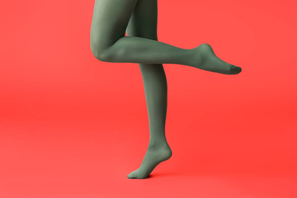 Beautiful young woman in tights on color background - Valokuva, kuva