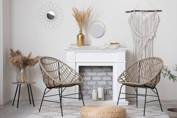 Stylish fireplace with armchairs in interior of living room - Φωτογραφία, εικόνα