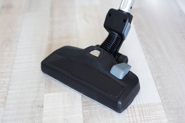 close up of modern vacuum cleaner over wooden floor - Photo, Image