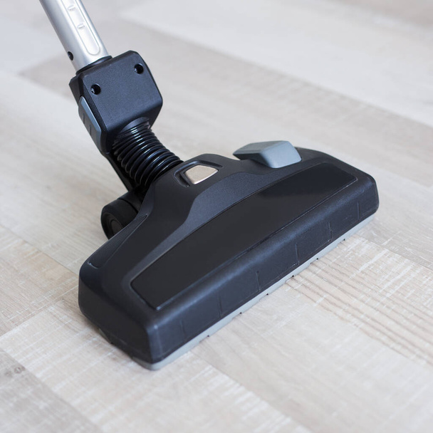 close up of vacuum cleaner over wooden parquet floor background - Photo, Image