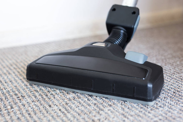 close up view of modern vacuum cleaner over carpet - Photo, Image