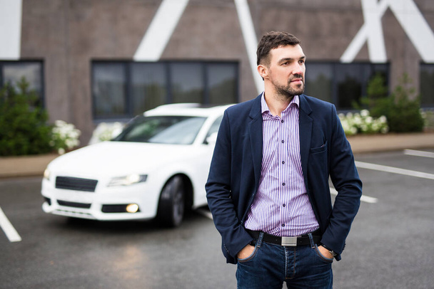 portrait of handsome man posing with his white car - Photo, Image