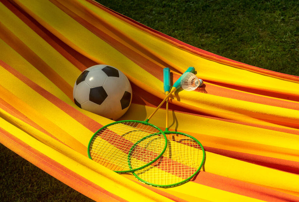badminton rackets and a soccer ball in a hammock - Photo, Image