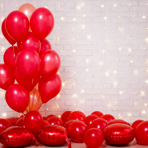 Valentine's day background - bunch of red balloons over white brick wall with copy space - Photo, Image