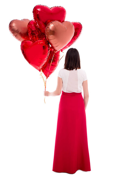 valentine's day or birthday concept - back view of woman with red balloons isolated on white background - Photo, Image