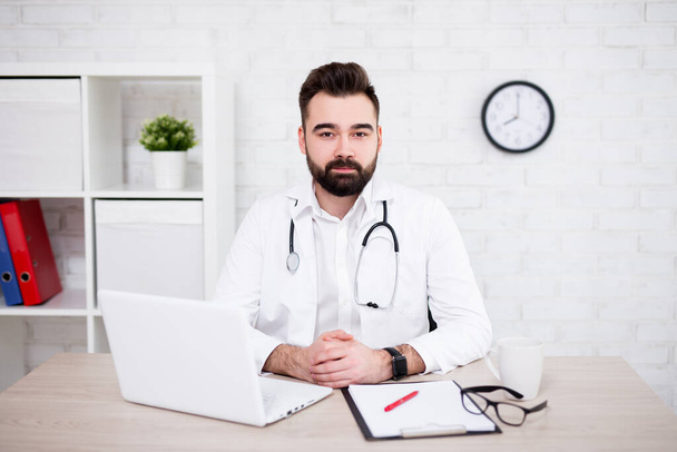 portrait of male doctor using laptop in modern office office - Photo, image