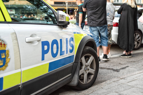 Stockholm, Sweden - August 3, 2019: Scenic view of the police car with text polis on sweden in the Old Town Gamla Stan - Photo, Image