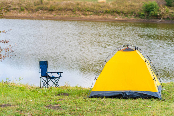 Rest with a tent in the woods by the river. The pleasure of nature. Camping with a tent. Fresh air. - Photo, Image