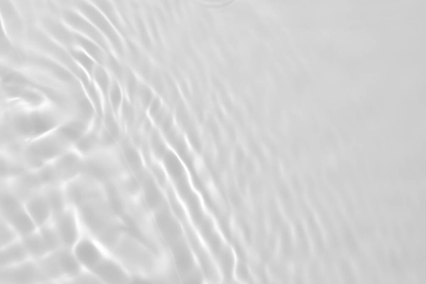 Closeup of desaturated transparent clear calm water surface texture with splashes and bubbles. Trendy abstract nature background.  - Photo, Image