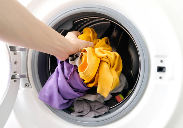 man's hand Pick up clothes Washing machine.Clean and Healthy Concepts - Foto, Imagem