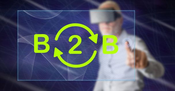 Mann mit vr-Headset berührt mit dem Finger ein b2b-Konzept auf einem Touchscreen - Foto, Bild