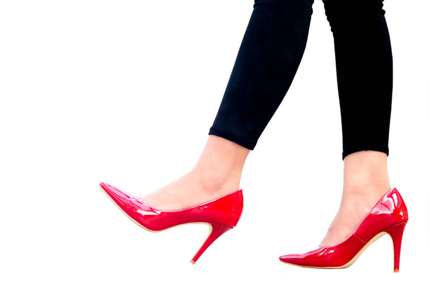 leg of woman beauty put on red high heels on isolated white background.Beauty and health concepts - 写真・画像