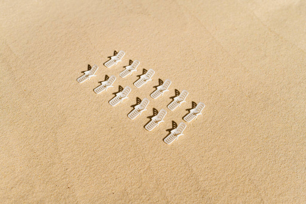 Aerial view of many sunbed, lounge on sandy private beach. copy space. Summer and travel concept. Minimalism - Photo, Image
