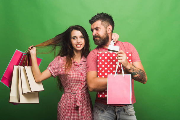 Macho holds shopping bag. Couple in love hugs - Foto, immagini