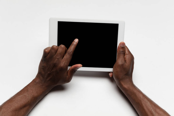 Close up of human hand using tablet with blank black screen, education and business concept - Фото, изображение
