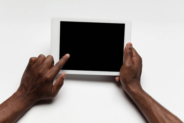 Close up of human hand using tablet with blank black screen, education and business concept - Foto, imagen