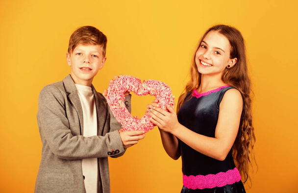Couple relations. Little boy give pink heart to girl. Valentines day. Holiday celebration. First love. Be my Valentine. Love my Valentine. Valentine concept. Sincere honest true romantic feelings - Fotografie, Obrázek