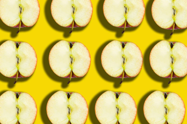 Sliced apple pattern on yellow background, minimal concept - Фото, изображение