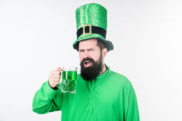 Colored patricks beverage. Green color part of celebration. Irish beer pub. Celebration irish culture. Man bearded hipster hat patricks day drink pint beer. Saint patricks day holiday. Cheers concept - Zdjęcie, obraz