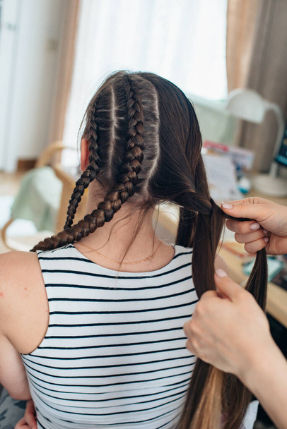 Weave braid at home, hairstyle. Long hair. - Foto, afbeelding