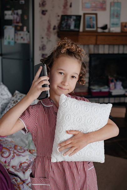 Girl at home emotionally talking on the phone. - Fotó, kép