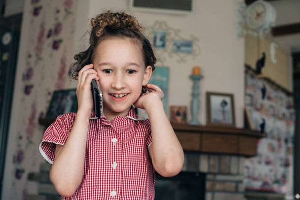 Girl at home emotionally talking on the phone. - Valokuva, kuva