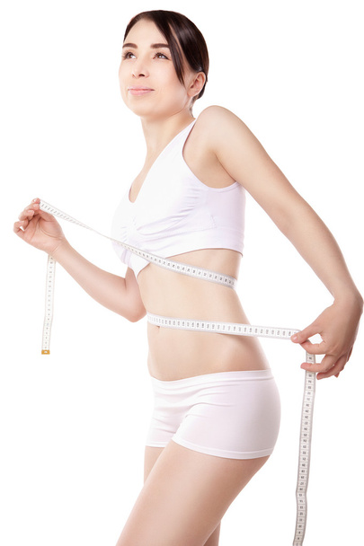 Slimming woman measuring thigh with tape - Zdjęcie, obraz