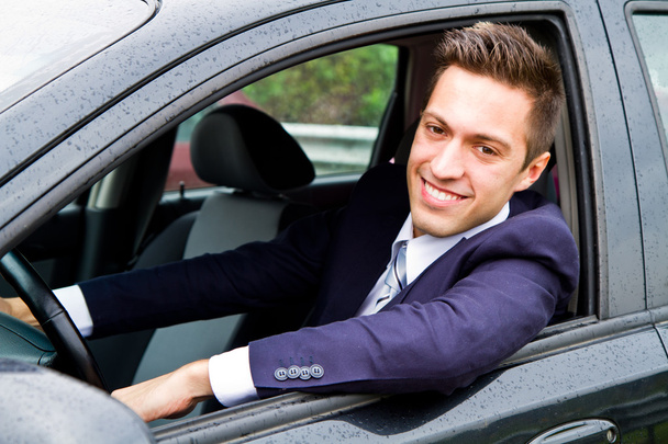 Portrait of an handsome guy driving his car - Photo, Image