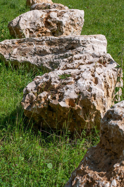 close-up of large jurassic limestone boulders lying on a meadow in sunlight - Foto, Imagem
