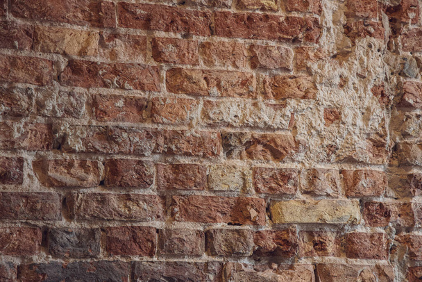 beautiful interesting interesting background wall of old red bricks with gray mortar - Фото, изображение
