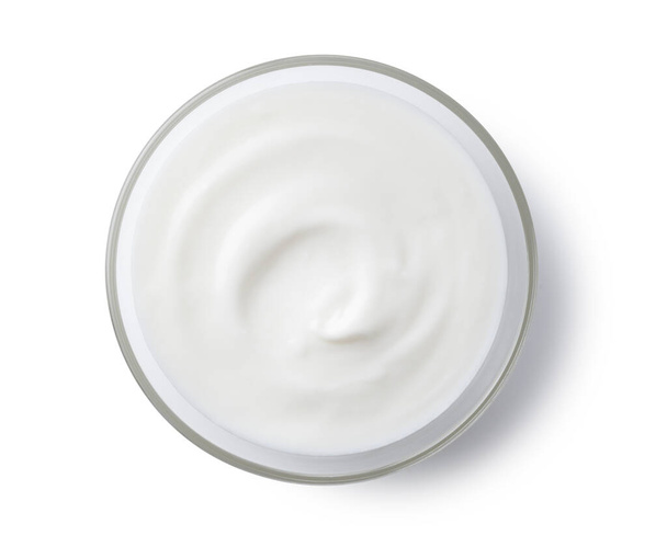 Yogurt in a glass bowl set against a white background - Zdjęcie, obraz