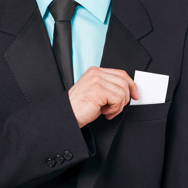 Part of body of business man who takes out business card from the pocket - Foto, imagen