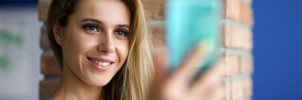 Happy girl taking selfie on smartphone indoors - Φωτογραφία, εικόνα