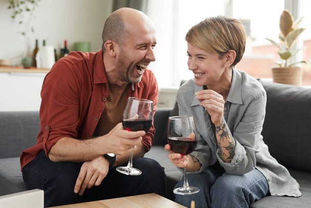 Ευτυχισμένο ζευγάρι πίνοντας κόκκινο κρασί - Φωτογραφία, εικόνα
