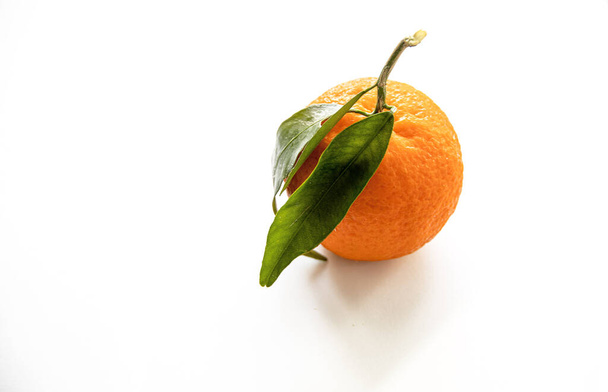 beautiful orange mandarin  on a white background isolated with green leaves - Photo, Image