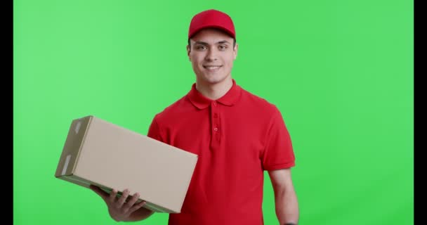 Friendly delivery guy with package gesturing thumb up - Footage, Video