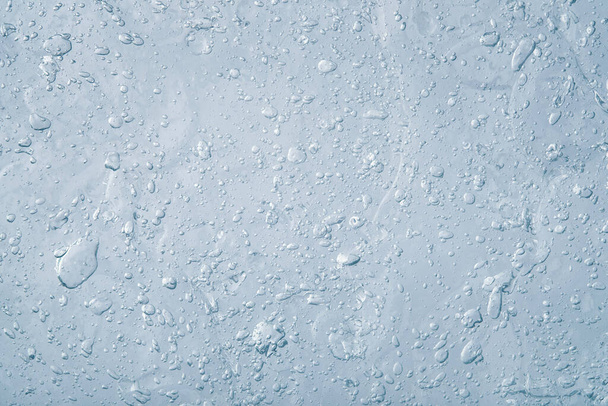 Fondo líquido azul abstracto. Textura de gel grueso transparente con muchas burbujas. Producto cosmético
. - Foto, Imagen