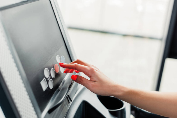 cropped view of woman pointing with finger at screen on modern treadmill  - Photo, Image