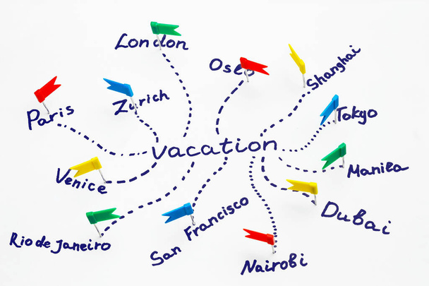 Napis "wakacje" i nazwy miast oznaczone pinami. Koncepcja planowania podróży - Zdjęcie, obraz