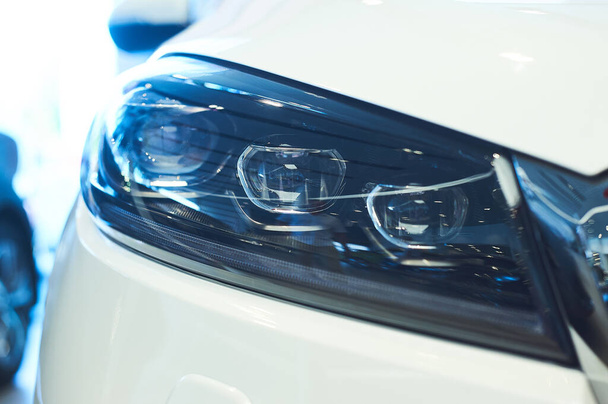 automobile headlights of new modern car. cold blue tones. closeup - Fotó, kép