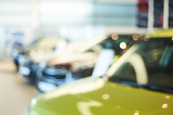 modern car showroom. blurred automobile hoods. not in focus background. copy space - Foto, afbeelding