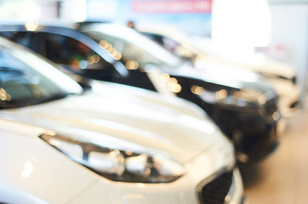 modern car showroom. blurred automobile hoods. not in focus background. copy space - 写真・画像