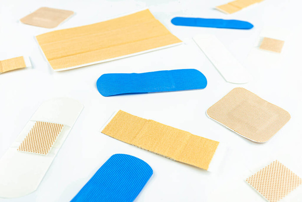 Background made of different types of wound patches, top view, selective focus, isolated on a white background. - Photo, Image